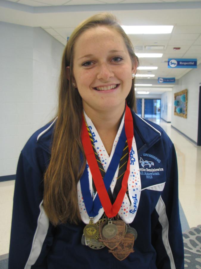 Catherine Bendziewicz poses with some of her favorite medals.
