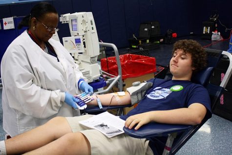 Alumni Macay Stephens gives blood during the last year September blood drive.