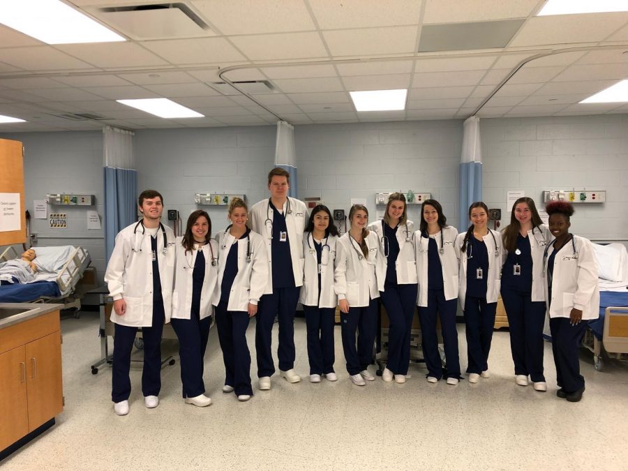 Health Science 3 and 4 pose in their new lab coats.
