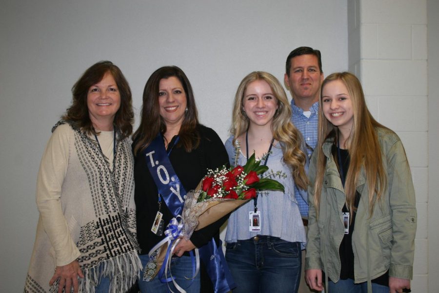 Ms. White poses with Ms. Pratt, Mr. Pratt and their daughters.