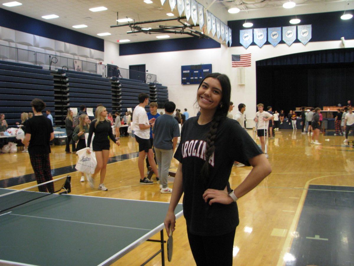 Dani Mejia plays Ping Pong during Senior Grad pick up.