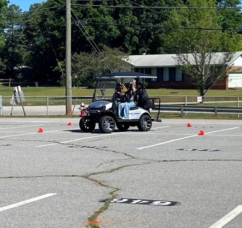 Students drive the cart during Prom Promise