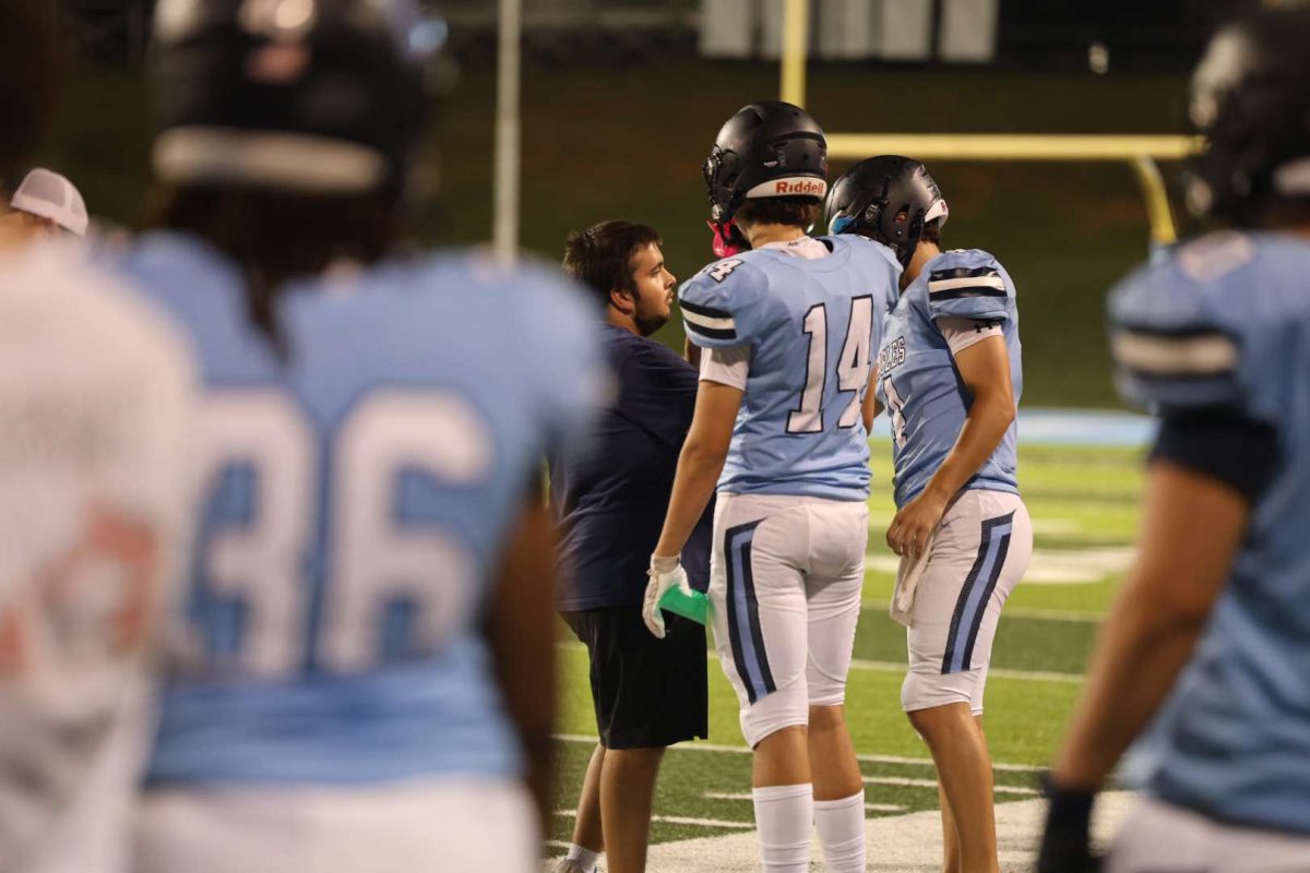 Zaden Co, football manager is on the field with 
#14 Nate Griffeth and Mac Berry