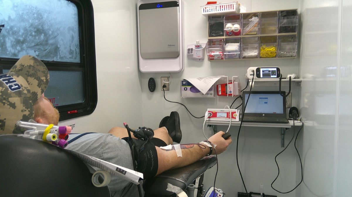 A parent volunteer is giving blood during the Chapin High blood drive.